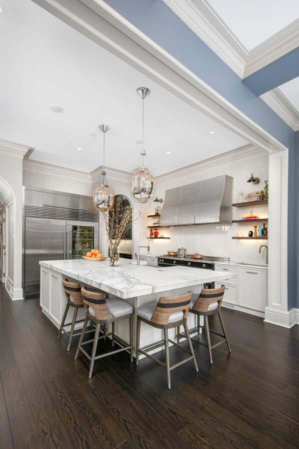 a cozy eat-in kitchen island featuring bright white and stainless appliances