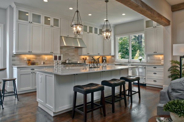 add captivating light fixtures to glow warmly on stainless appliances and white cabinets