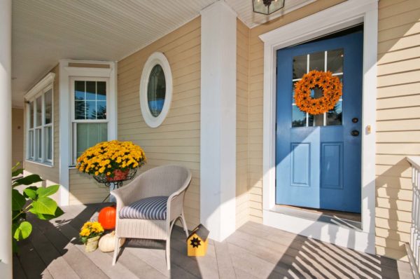 carolina blue front door on a tan house for whimsical porch
