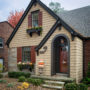 charming cottage style with pella tan front door color and beige siding exterior