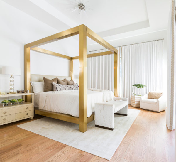 contemporary white bedroom with gold bed frame for a sense of grandeur