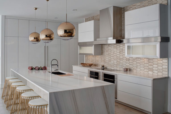contemporary white kitchen with stainless appliances and brass gold details looks exquisite and stunning