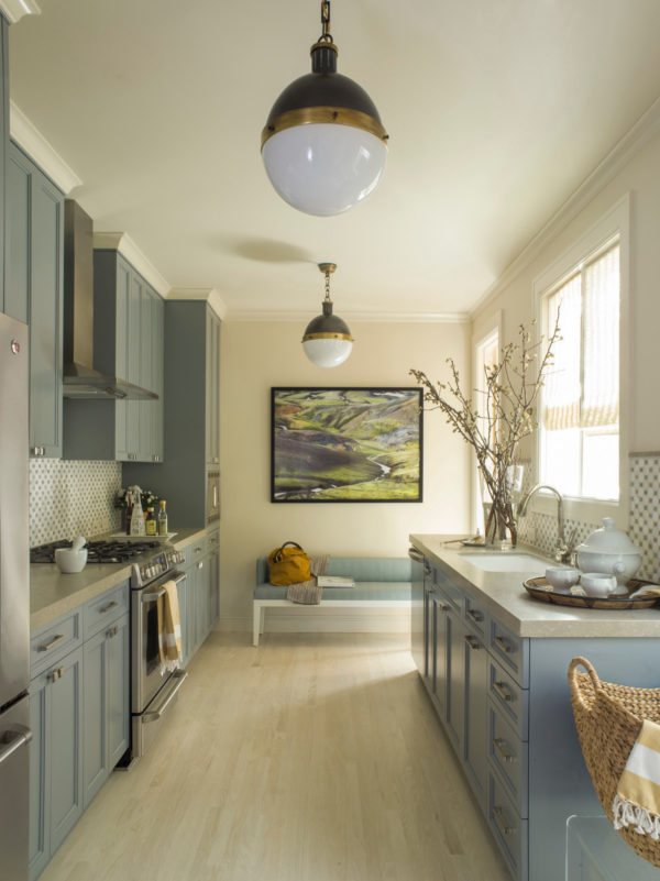 contemporary yet homey kitchen with blue cabinets and pale-yellow walls