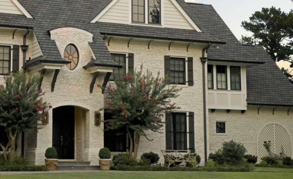 painted brick house in shell white and black bronze color windows