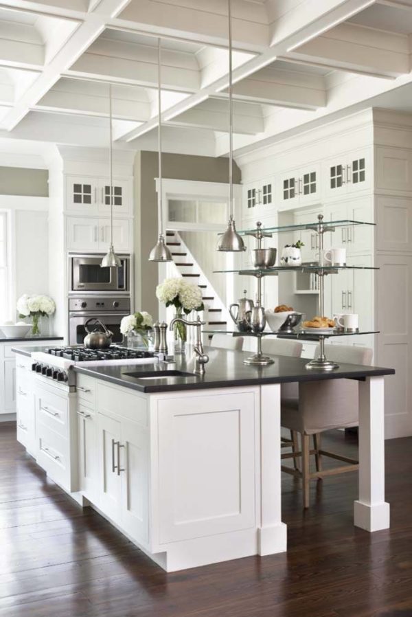 stainless appliances and installations create a theatrical look in this white country kitchen