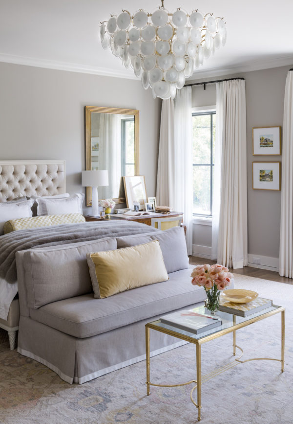 stunning master bedroom with white headboard and touches of gold