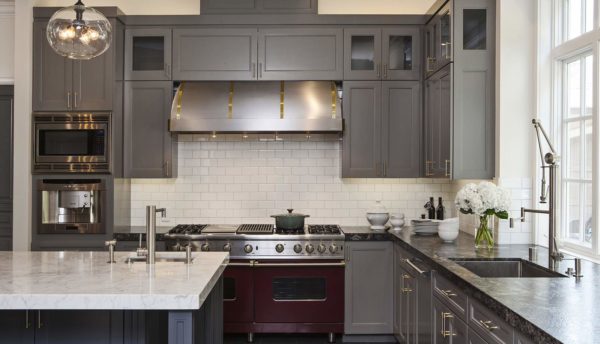 trendy kitchen featuring white tile backsplash stainless appliances and granite countertop