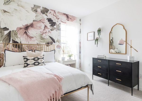 white and gold bedroom with floral patterns to evoke a feminine vibe