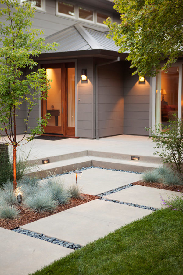 concrete path and front steps with yellow illumination can evoke an exquisite and trendy house design