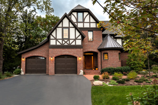 mix metal and traditional gable roof with your red brick exterior for a classic and charming home
