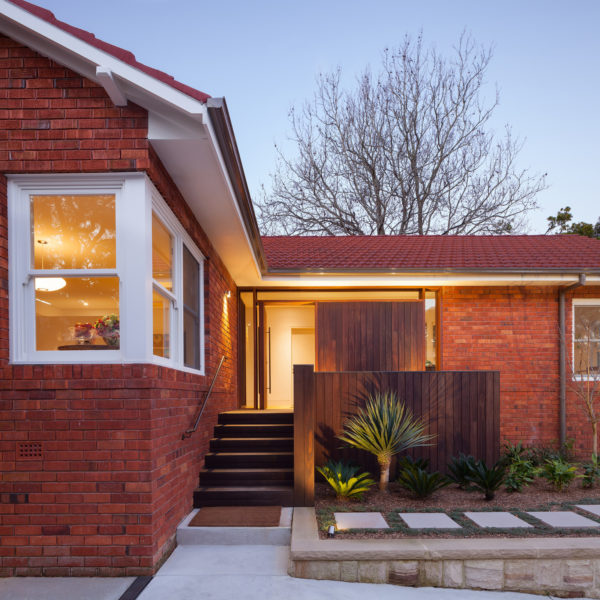 red brick house and red brick gable roof mixes color, wood, and metal elements for a timeless yet modern look