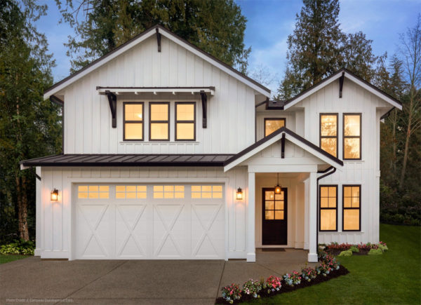 carriage style garage door with a barn house ambiance in this stunning all-white house