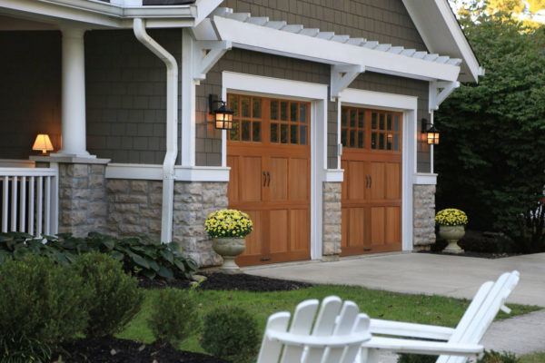 classy and natural barn style garage doors with sophisticated glass windows in a modern home
