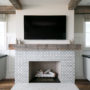 clean white tiles in front of cement mosaic fireplace, featuring beige walls and wood flooring