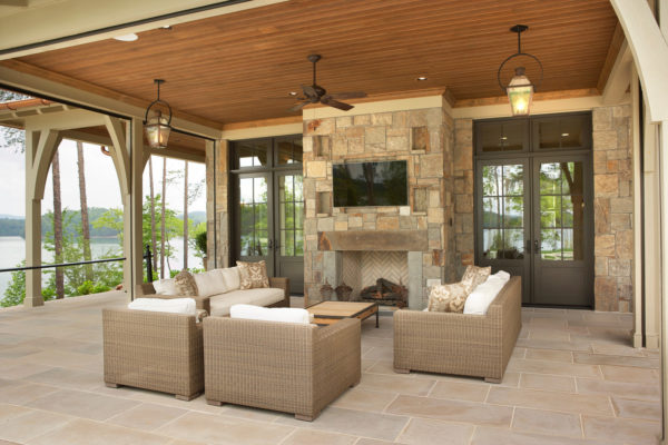 country estate living room featuring stone wall fireplace and indiana limestone tile floor