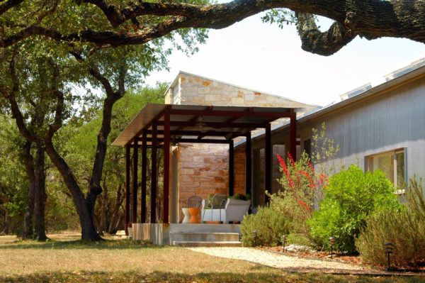 embrace the simplicity of an urban metal exterior with corrugated metal pergola and generous roof