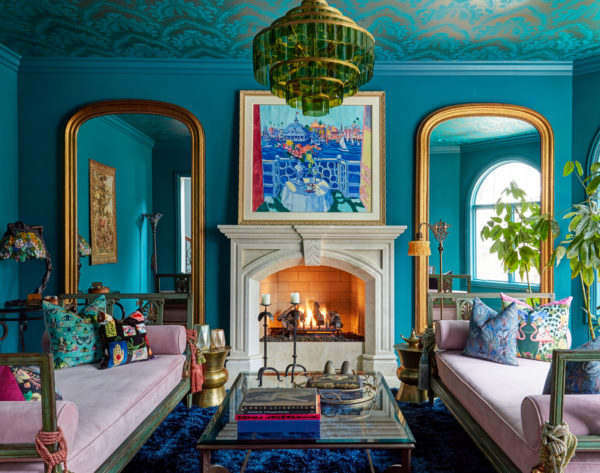 get a funky and colorful vibe in this moroccan-inspired living room with blue walls and gold arches
