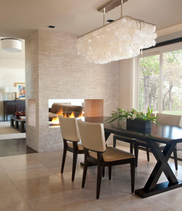 go classic and trendy with travertine and beige tile floors in front of luxurious fireplace