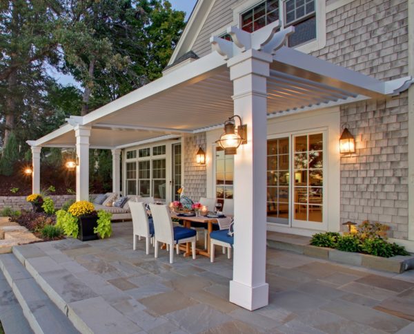 large classic patio featuring metal pergola and a cozy outdoor dining table