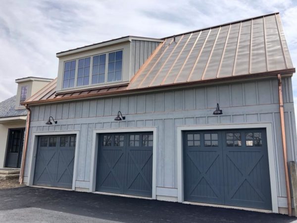 lifting faux wood garage doors in a farmhouse style home inspired by classic barn elements