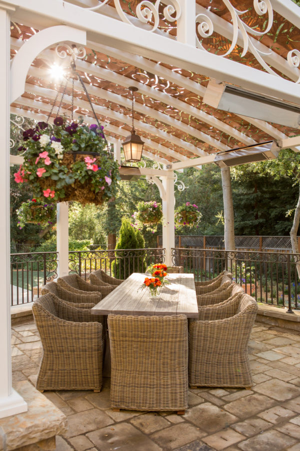 try a metal pergola in this elegant patio with ornamental rails for a fairytale-like ambience