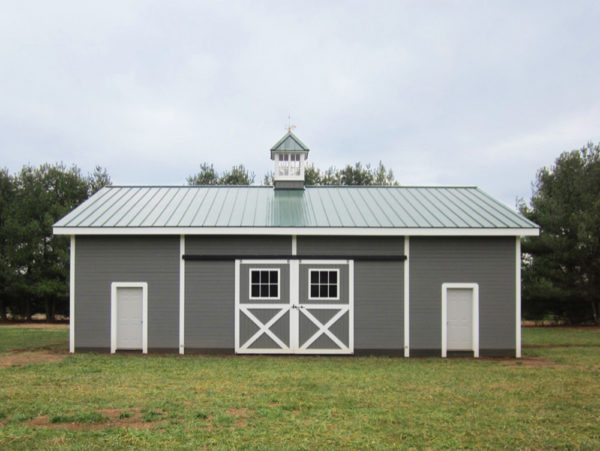 try bay wood barn style garage doors that match the grey siding and green roof
