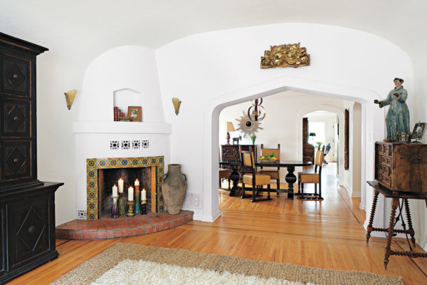 tuscan wood floor as backdrop for earth-tone tiles in front of corner fireplace