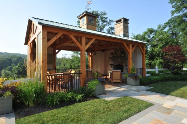 use ponderosa pine siding and metal roof pergola for a charming farmhouse deck