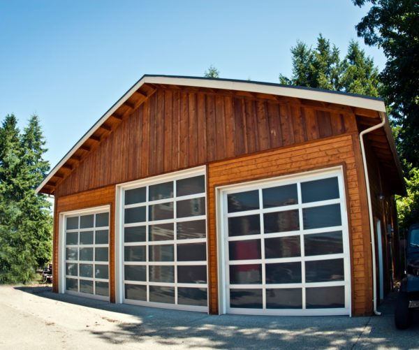 use windows in your garage doors with white trimming while embracing the classic barn style