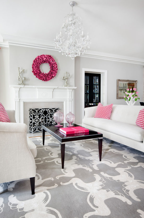 a gray and white living room with touches of pink for an elegant yet feminine look