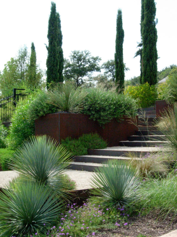 all green plants to create a monochromatic yet soothing environment of modern steel retaining walls