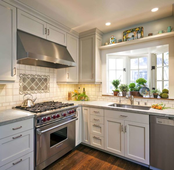 an elegant kitchen remodel featuring bay window over sink and limestone countertops