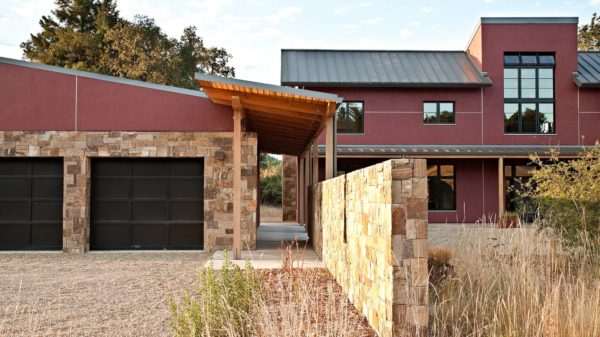 combine stone with concrete in this trendy stucco home featuring a detached garage and narrow breezeway
