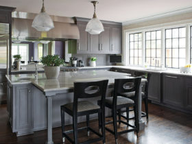 complement grey-stained walnut cabinets with dark wood floor for a classically elegant eat-in kitchen