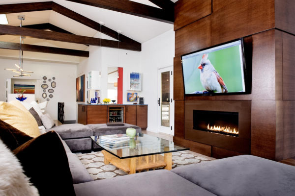 go for a contemporary open concept room with white walls, wood elements, linear fireplace, and tv