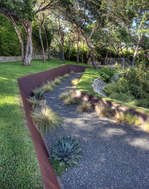 industrial retaining wall featuring corten steel to create a cool and secluded pathway
