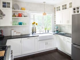 large bay window over sink in an all-white kitchen for a bright and modern atmosphere