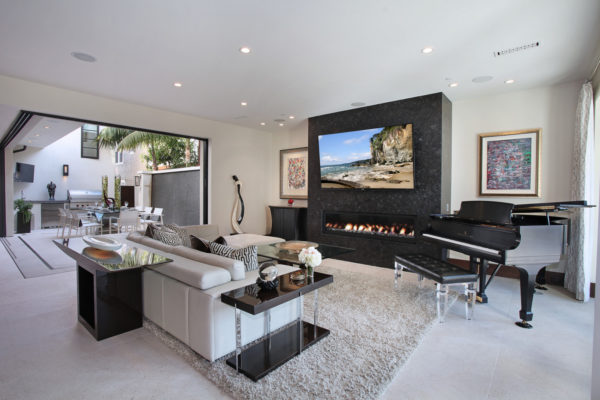 mix contemporary design and artistic touch for a rich seaside living room with linear fireplace and tv mount