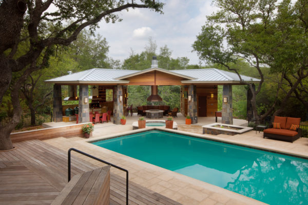 try a c-shaped pavilion around a fire pit for a cozy pool house with bathroom