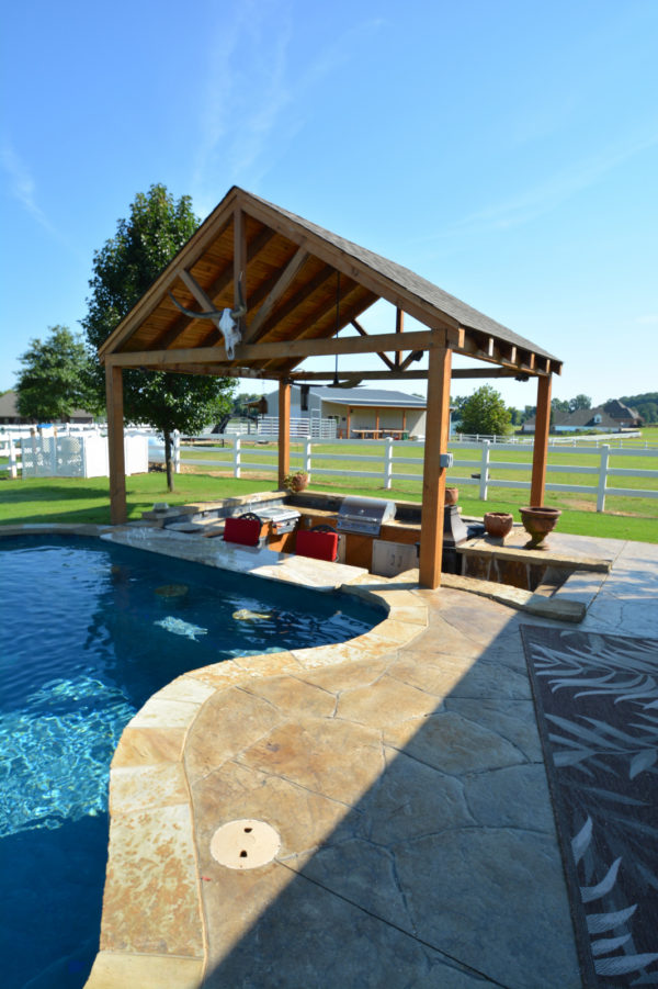 combine countryside and rustic charm with stamped concrete pool deck and cozy hot tub