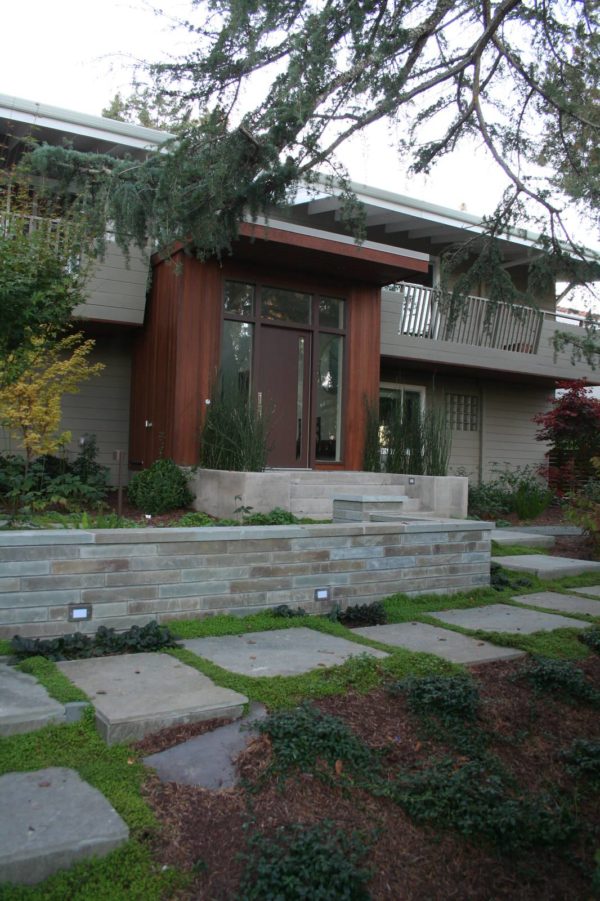 complement your front yard retaining wall with large monolithic steppingstones for a modern yet classic design