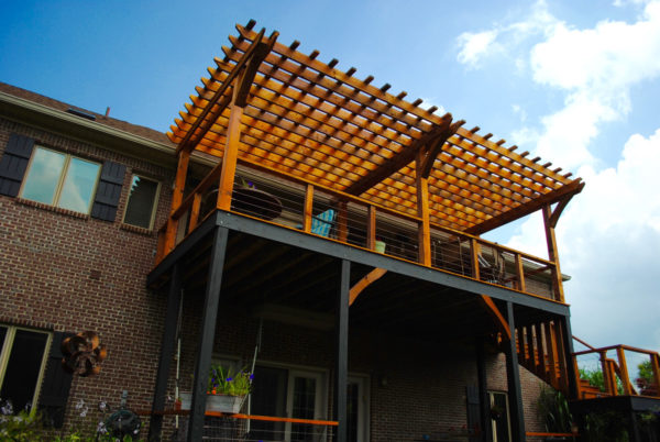 embrace the outdoors in this second-story deck with fun pergola roof and cedar wood