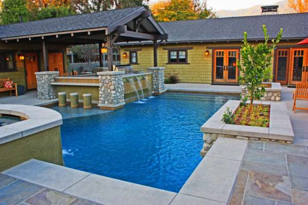 evoke craftsman style in this traditional backyard with a stamped concrete pool deck