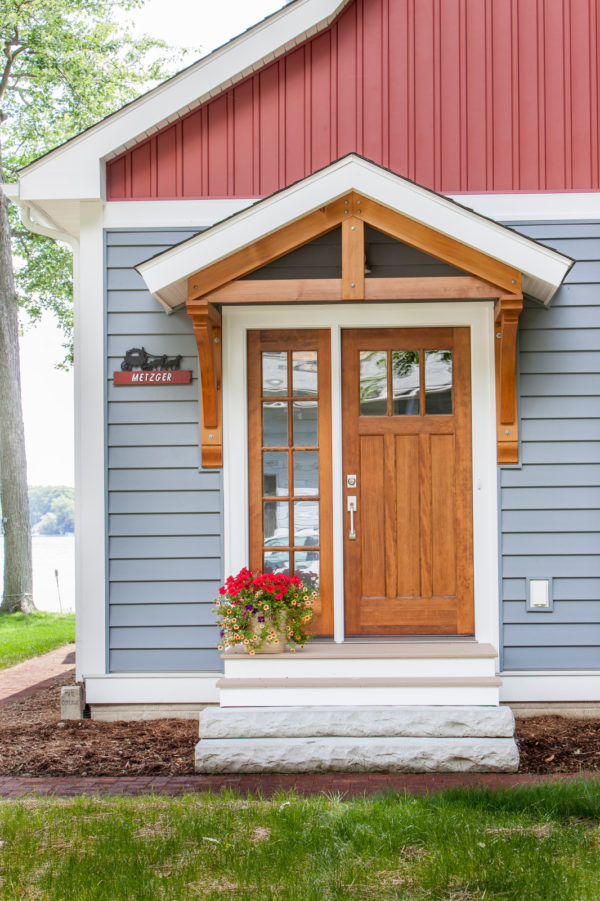 pair a traditional roof over door entry with colourful vinyl siding for a quirky vintage look
