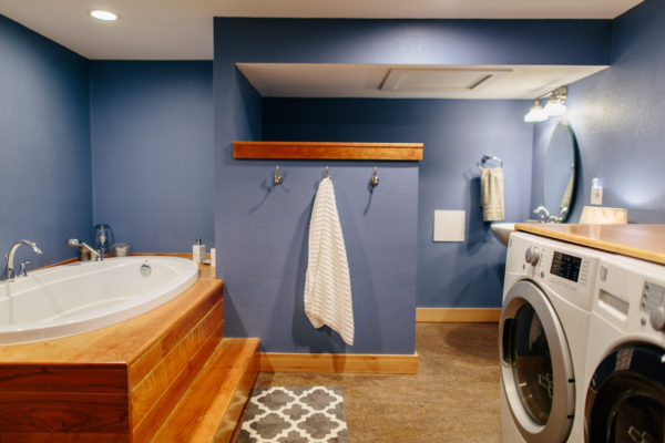try a blue bathroom with wooden accent plus a countertop above the laundry area