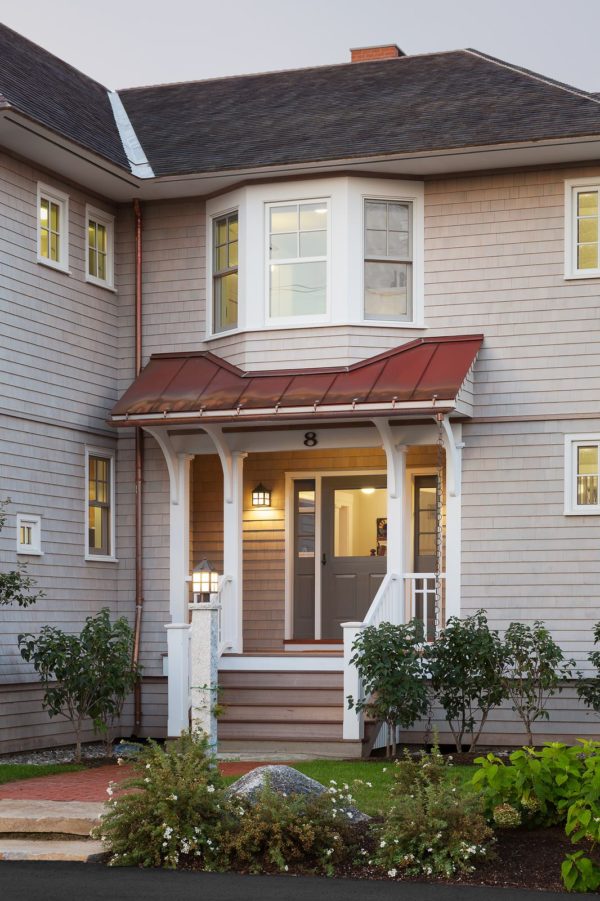 use real copper for roof over door entry in this victorian-inspired cottage home