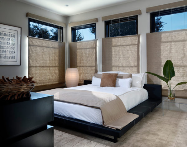 combine grey walls and black furniture with brown blinds in this modern carpeted bedroom
