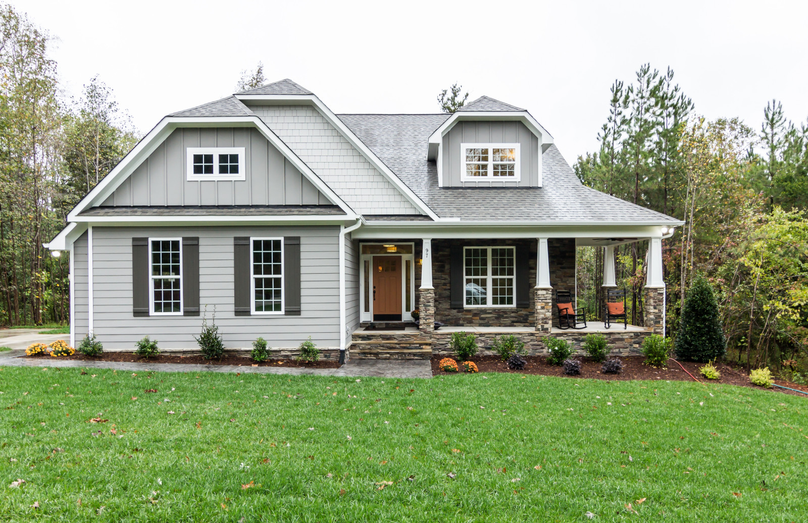 Discover the Charm of a Gray House with Stained Shutters: Get Inspired Now!