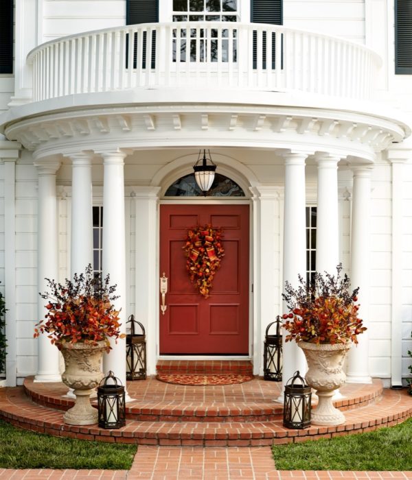 embrace classical charms with a festive wreath on the muted red door and white pillars