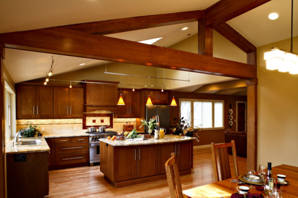 after: a welcoming open kitchen and dining room plan featuring dramatic rafters and wooden beams